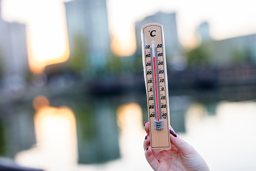 thermometer displaying high 40 degree hot temperatures in sun summer day