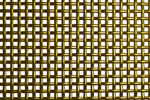 Metal gold grid. A fence made of mesh. Square cells.