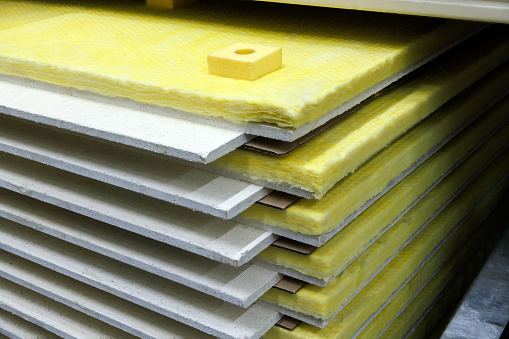 insulated dry wall sheets packs stack in home improvement store.