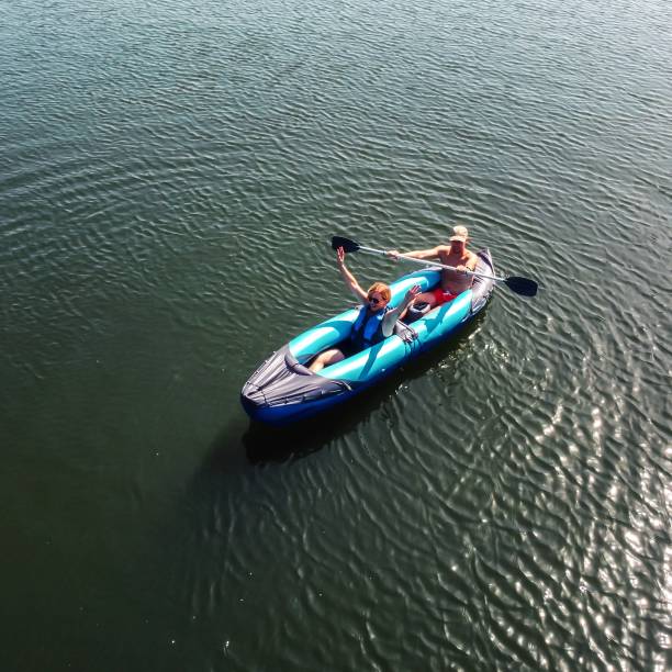 Mother and son on a kayaking adventure in the lake.