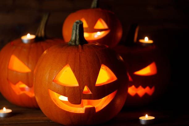 istock Three Halloween Pumpkins and candles 1698722761