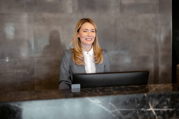 istock Smiling Female Receptionist Looking at Camera 1698737822