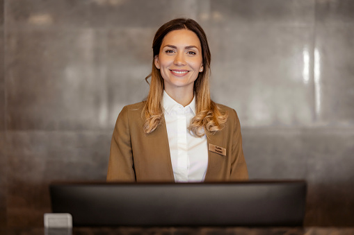 Hotel receptionist talking customers at lobby