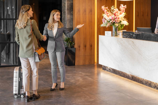 istock Handshaking in Front of Reception Hotel Counter 1698744905