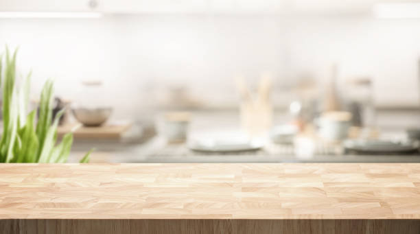 istock Selective focus.End grain wood counter table top on blur white cozy kitchen in morning background 1698754302