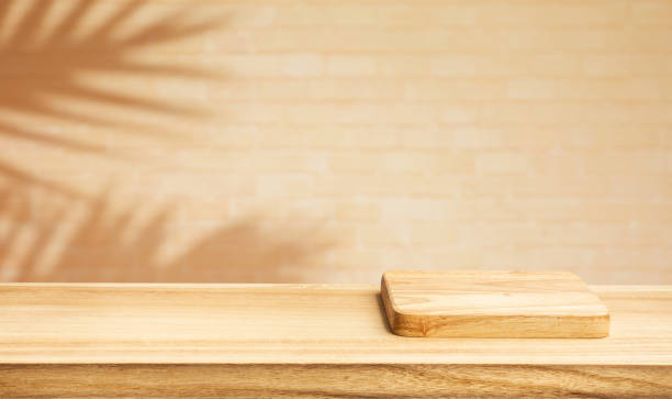 istock Selective focus.Wood table or  product display platform design with shadow plam leaf on wall background. 1698754354