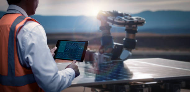 istock Engineers have used a tablet to control the robot to clean the module solar so that the power generation can operate at full capacity. Alternative energy to conserve the world's energy 1698768923