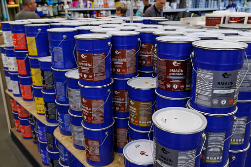 large stack of enamel paint buckets in home improvement store in Tula, Russia in June 22, 2022