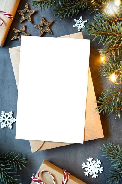 istock Blank white paper card with brown envelop, Christmas pine and handmade gift box on grey background. 1698773287