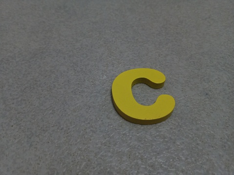 Children's educational toy in the form of the letter C