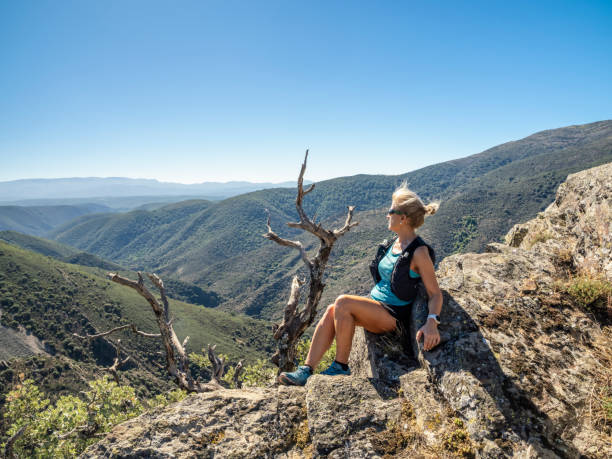 istock Woman on top of a mountain 1698800637