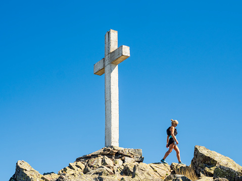 Cross, Catholic symbol, on the top of a mountain