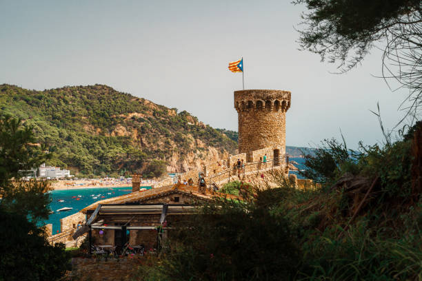 City walls of Tossa de Mar with the main beach Platja Gran in the background. Villa Vella.