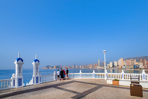 Tourists at the Plaça del Castell - Castle Square, a viewing point protected by white balustrades with outstanding views on Benidorm and over the sea