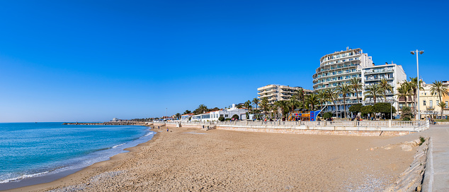 Beach and promenade of Sitges, a town belonging to Barcelona in Catalonia (6 shots stitched)