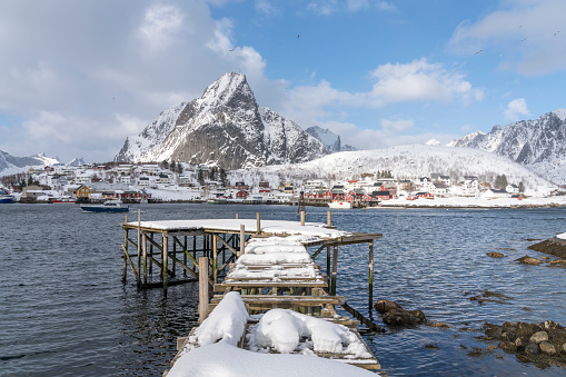 Winter view on wooden cottages in winter in village of Reine on tiny island in the Lofoten archipelago in Norway.