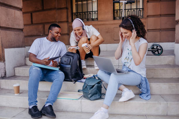 istock Multiracial group of college students having fun in front of university building while waching photos on mobile phone 1698866095