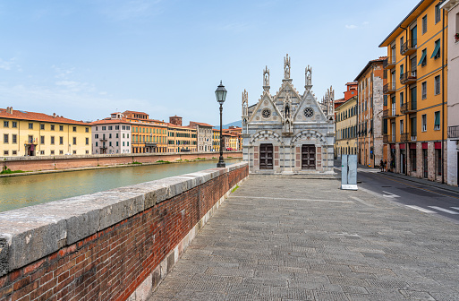 Beautiful sight in Pisa with the Arno River and the Church of Santa Maria della Spina on a sunny summer day. Tuscany, Italy.