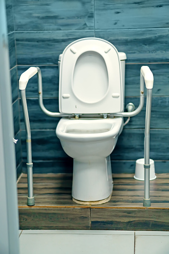 Toilet with handrails and railings for people with increased needs