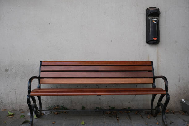 istock wooden bench against the wall and ashtray 1698876138