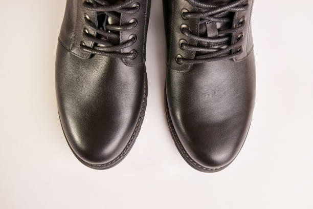 istock Black leather men's boots on a white background. Warm shoes for winter. 1698889659