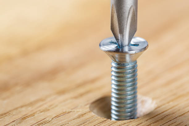 istock screwdriver screw in a wood oaks plank 1698892432