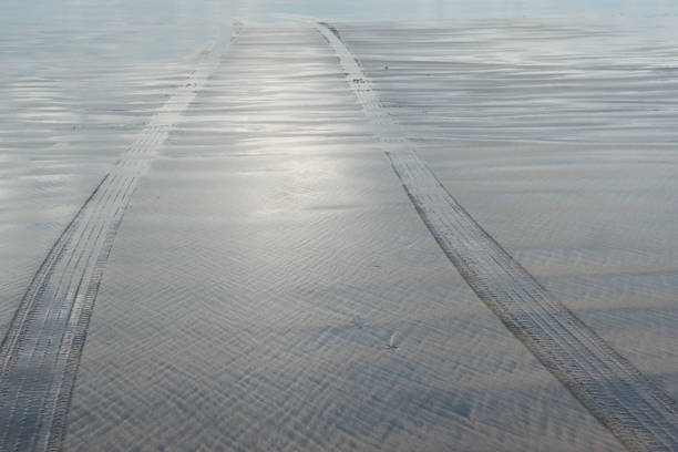 Tire tracks running into the sea, Devon UK.
