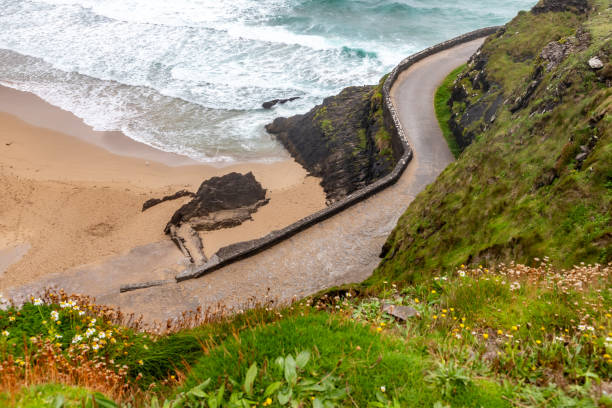 istock Road to Coumeenoole beach with Cliffs and vegetation 1698923596