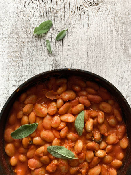istock White beans in tomato sauce and herbs. 1698962027