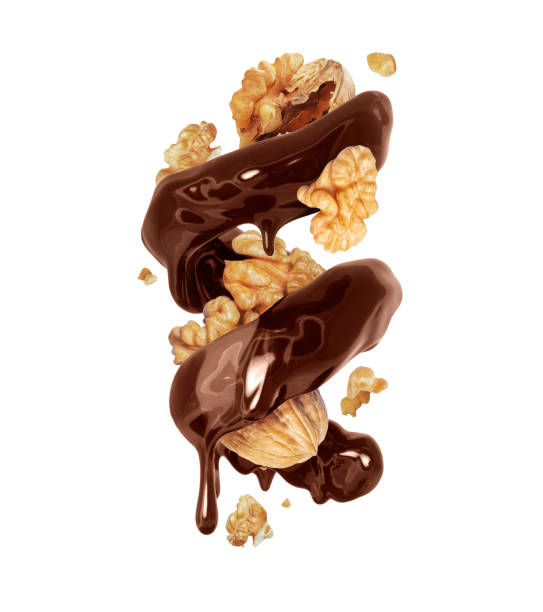 istock Glossy brown spiral made of melted chocolate with walnuts isolated on white background 1698977762