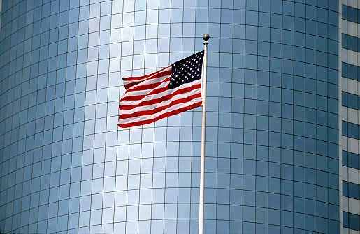 American flag in front of an office building in Manhattan,New York, USA