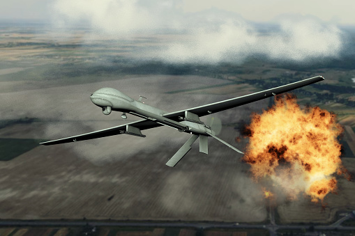 Military combat drone dropped bombs, blowing up military facilities, flying in the clouds, aerial view, drone attack, combat drone in the sky, war in Ukraine