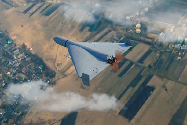 istock Military kamikaze drone flying in the clouds over rural landscape,3d render. 1699012807