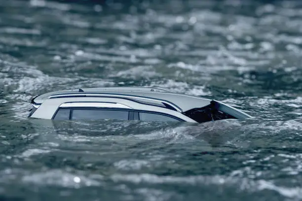 Photo of Flooded car floating in the water flow, flooding after the rains, the breach of the dam in Ukraine.