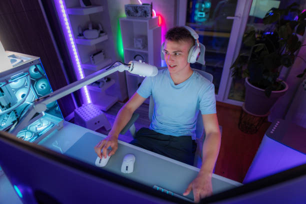 istock Teenager Talking Into a Microphone While Playing Video Games 1699024968