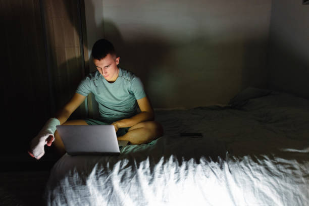 istock Teenager Working on a Laptop at night 1699025013