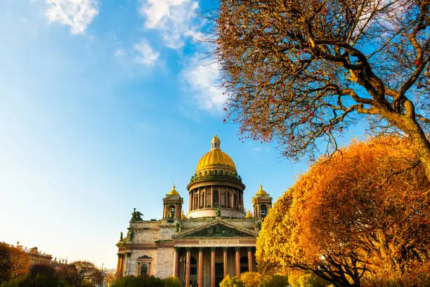 Saint Isaac's Cathedral in Saint Petersburg, Russia. Autumn cityscape with yellow trees at sunset