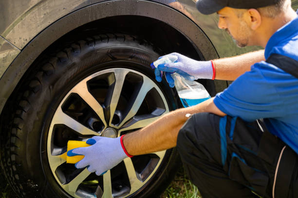 istock Man worker washing car alloy wheel. 1699044241