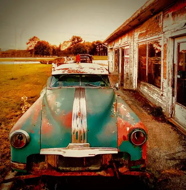 The once proud auto sits in a Midwestern junk yard rusting away