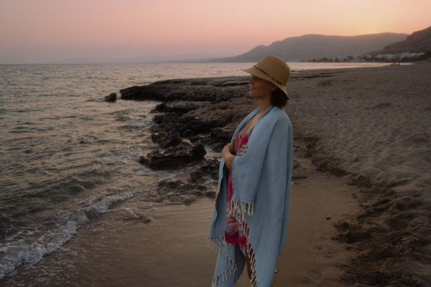 istock Latinx woman overlooking a Greek beach during sunset 1699055813