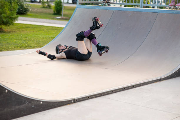 istock Mature Woman Falling at the Skateboard Park while Roller Skating 1699081869
