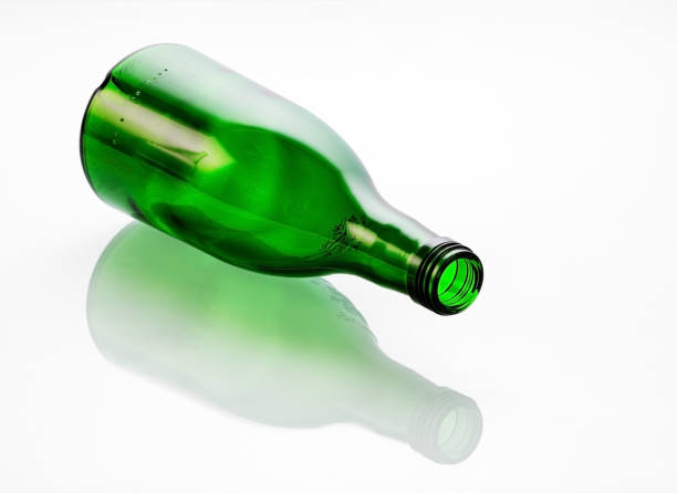 istock A green glass bottle lying on its side is beautifully reflected in a mirror background 1699093854