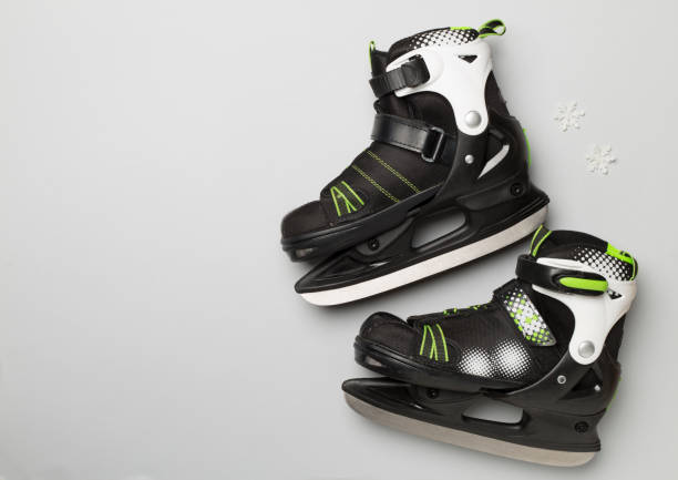 istock Ice skates on color background, top view 1699104059