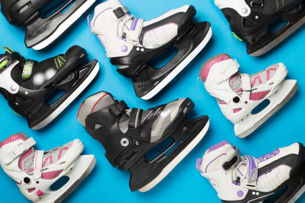 istock Many ice skates on color background, top view 1699105142