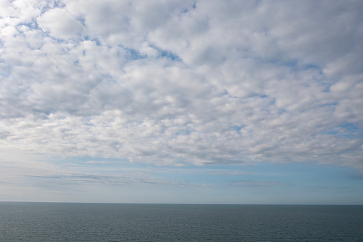 Aerial view of endless sea and cloudy sky.