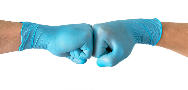 Two medical workers making a fist bump gesture , isolated on white background