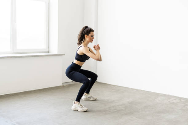 istock Young beautiful woman squats at home 1699129713