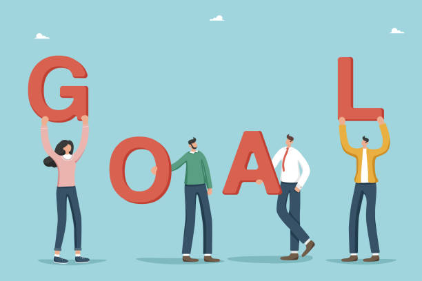istock People holding letters of word goal 1699132933