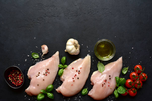 istock Raw chicken fillet with ingredients for making . Top view with copy space. 1699143169
