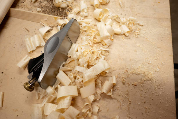 istock carpenter's plane with wooden chips 1699171353